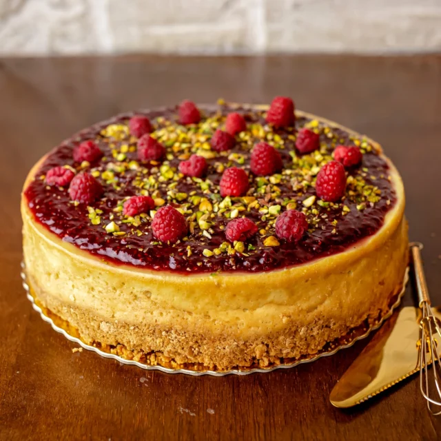 Cheesecake com calda e framboesas frescas